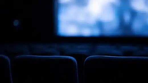 Sala cinema buia con poltrone vuote